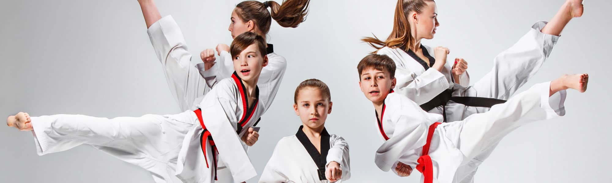 Children doing Karate kicks at class in Rhyl